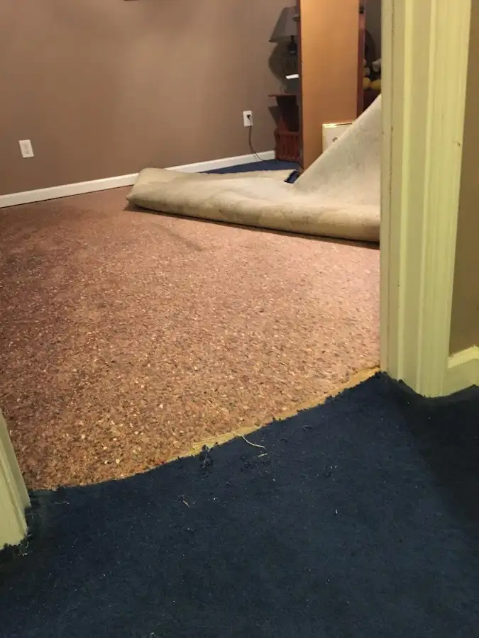 Carpet pad removal revealing water damage during Drying & Dehumidification in Pass Christian